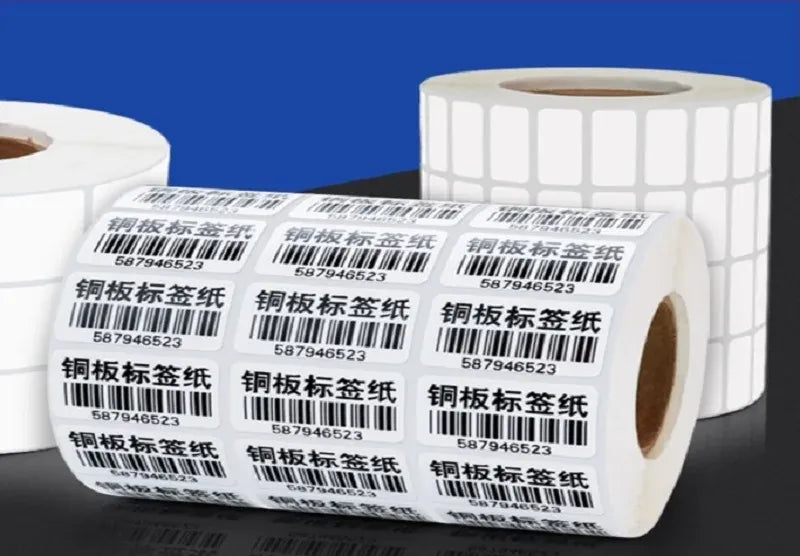 Multiple white label stickers with printed barcodes stacked on a roll