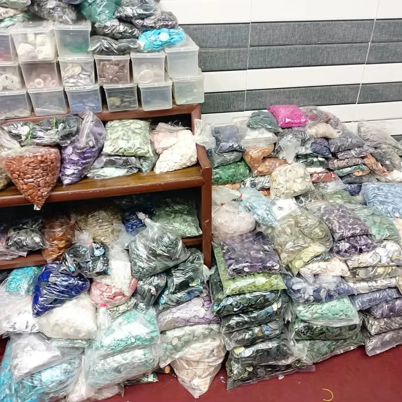 Bagged mixed-shape cabochon gemstone stones on retail display shelves
