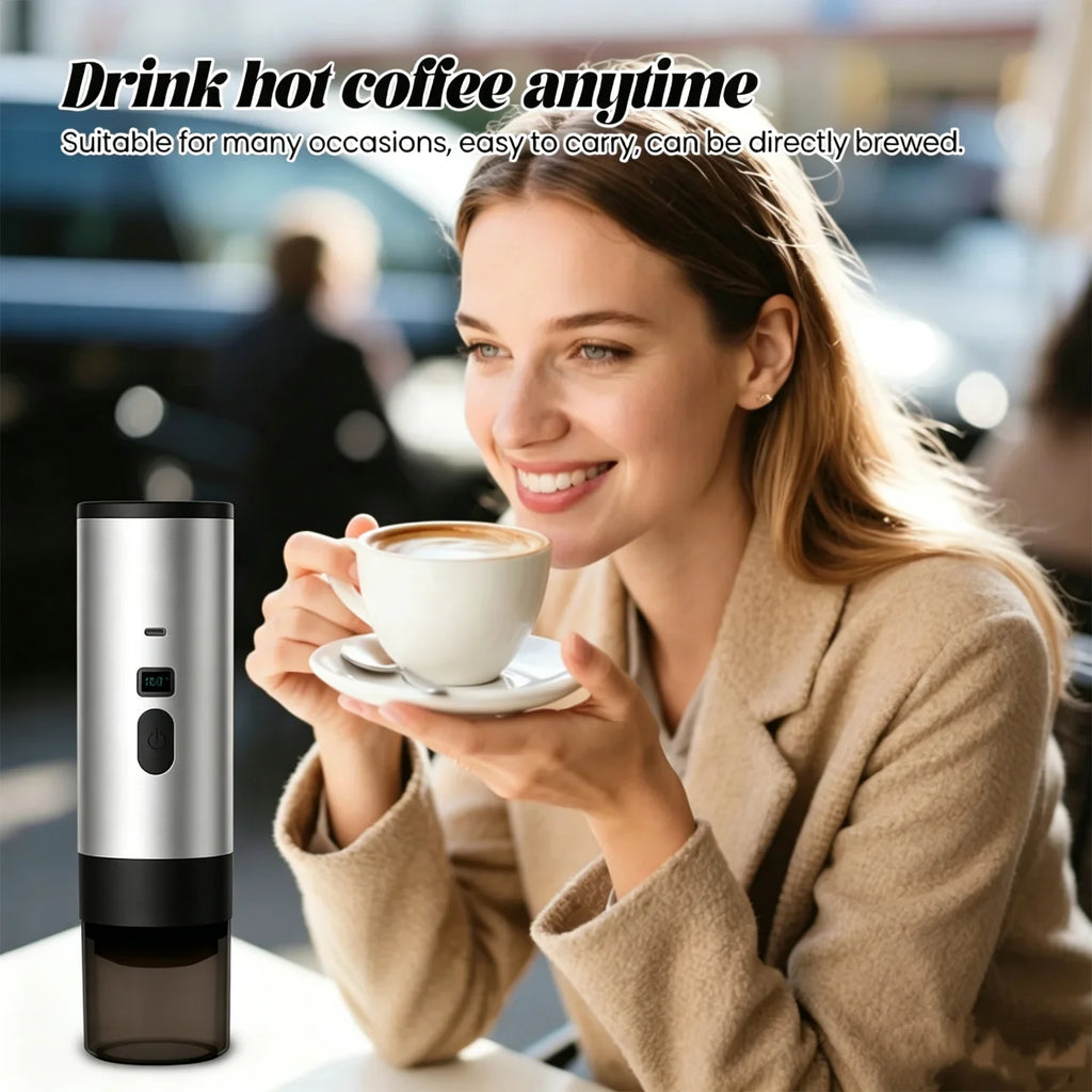 Portable silver coffee maker with digital display, compact cylindrical design for travel, brewing hot coffee anywhere.