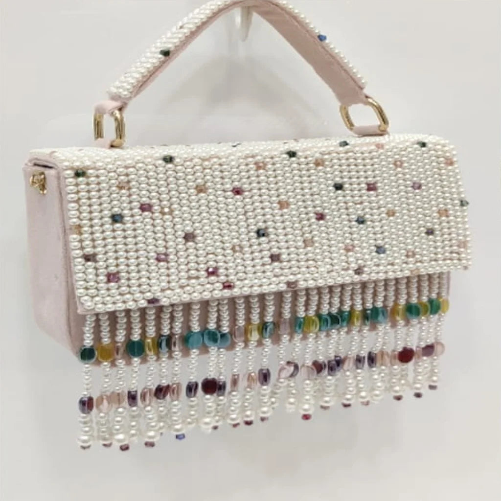 Luxury blush pink pearl-beaded evening clutch with colorful crystal tassel fringe and handle. Designer party handbag.