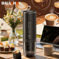 Balashov portable black electric coffee maker with LED status indicator on a table next to a cup and laptop.