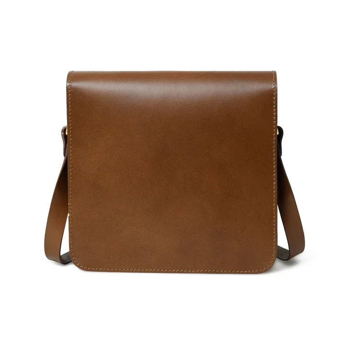 Minimalist brown leather designer crossbody bag with a sleek, square flap silhouette and adjustable shoulder strap.