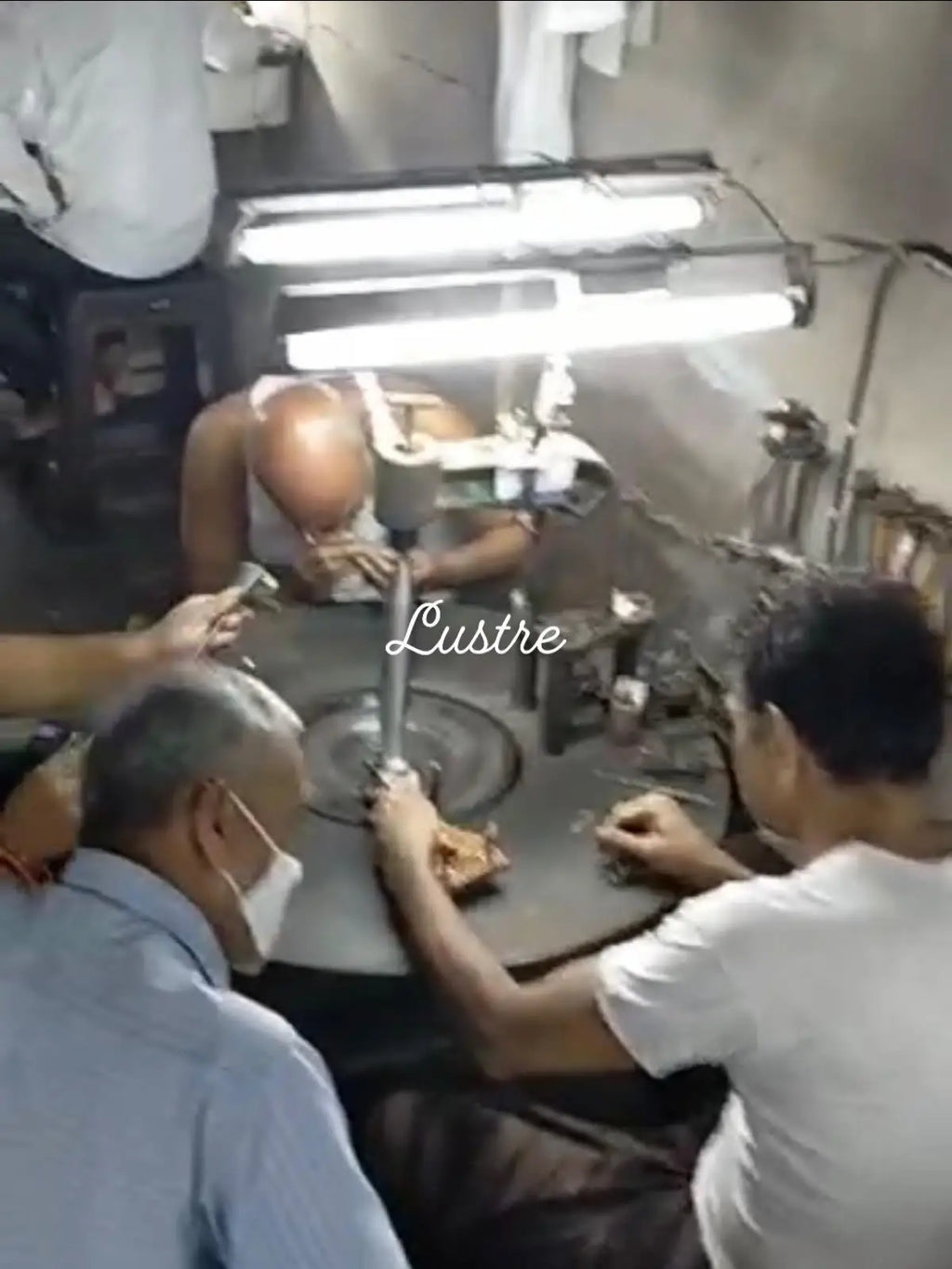 Jewelry workshop scene with craftsmen handling materials during bead strand production