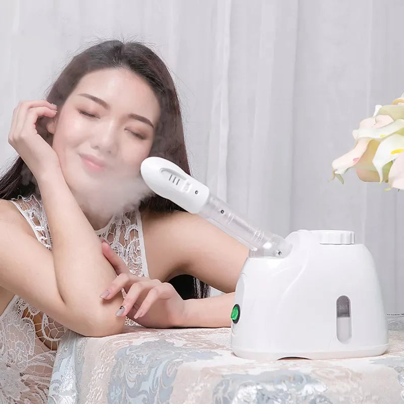 Woman using a white ozone facial steamer for deep skin cleansing and home spa warm mist treatment.