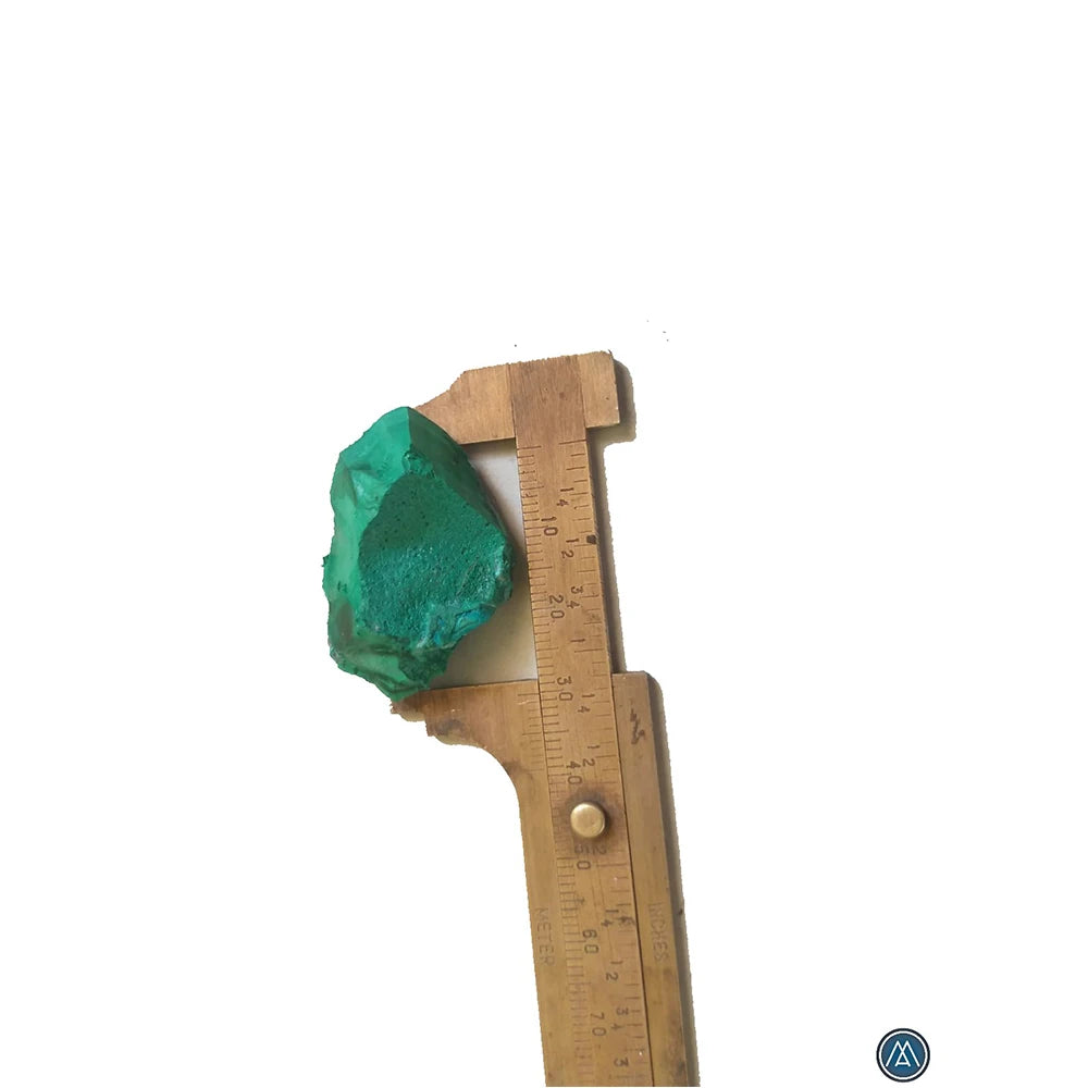 Raw green malachite crystal chunk with wooden measuring ruler for scale