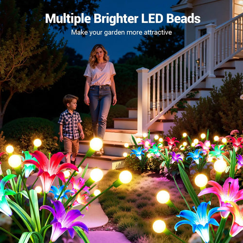 Color-changing LED lily and firefly solar lights illuminate a home garden pathway at dusk.
