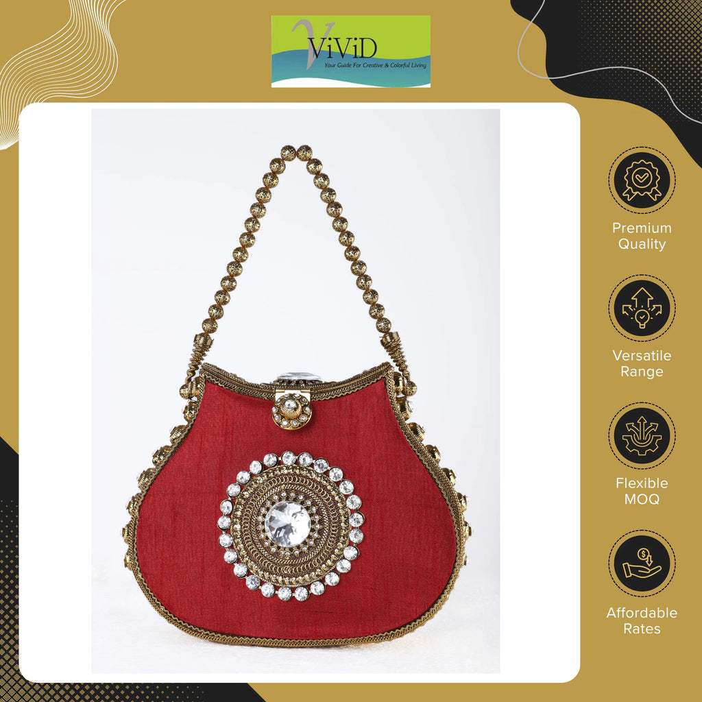 Red silk designer handbag with gold beaded handle, crystal center medallion, and kiss lock closure.