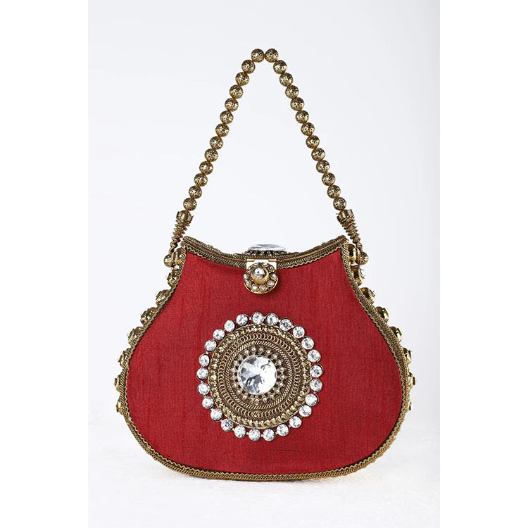 Red silk designer handbag with ornate gold beaded handle, crystal center embellishment, and kiss lock closure.