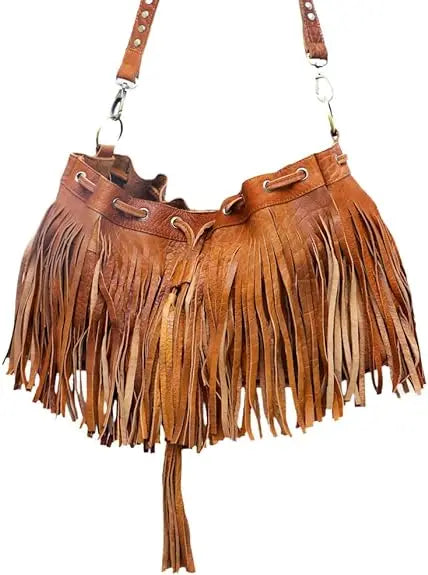 Tan leather boho bucket bag with fringe detailing, drawstring closure, and adjustable shoulder strap.