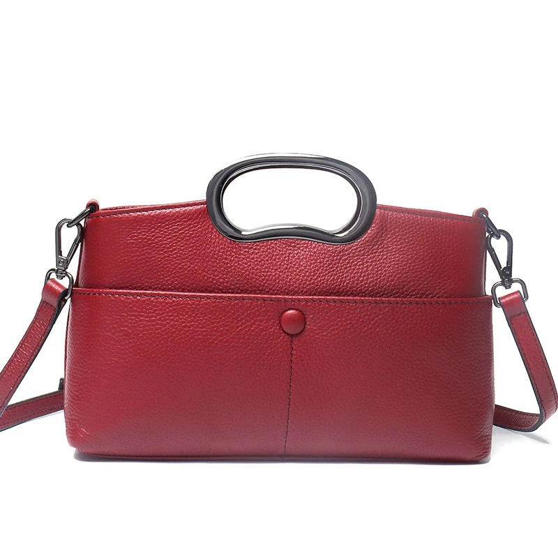 Red pebbled PU leather designer handbag with metal ring handle and detachable crossbody shoulder strap.