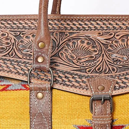 Bohemian hand-tooled brown leather sling bag with yellow Aztec saddle blanket fabric, floral pattern, and brass studs.