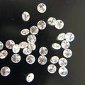 Loose round white diamonds, scattered assortment of small faceted stones
