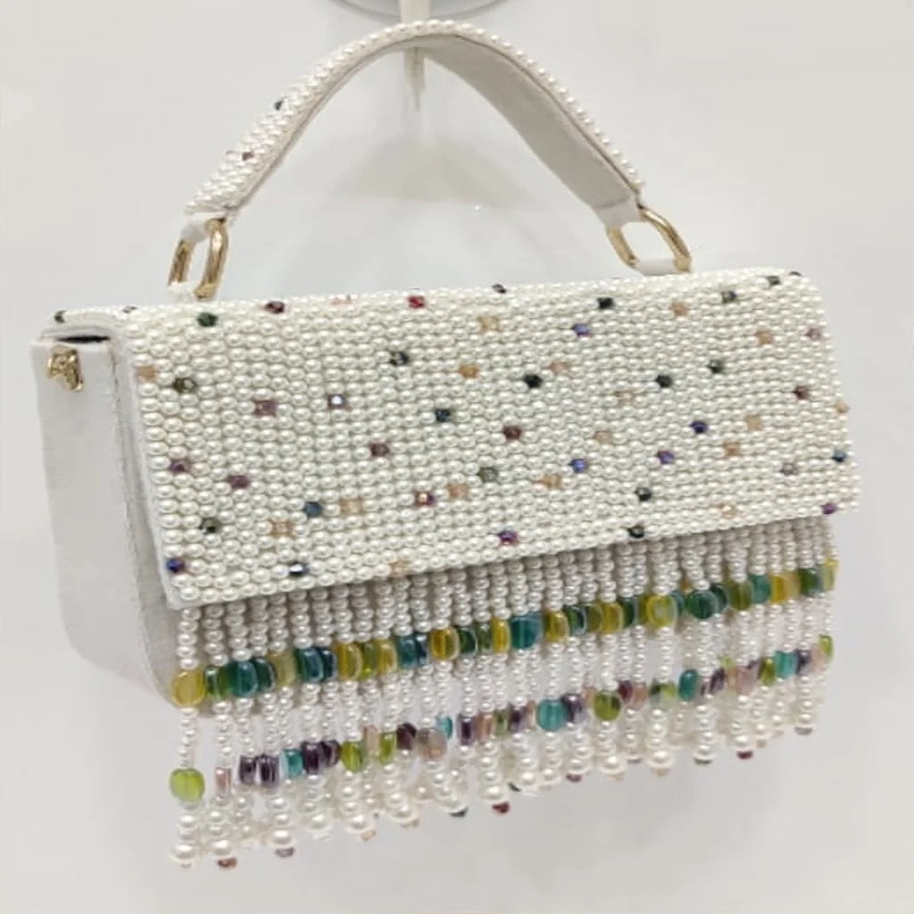 White luxury handbag with pearl beading, colorful crystal accents, and dangling beaded fringe for evening wear.