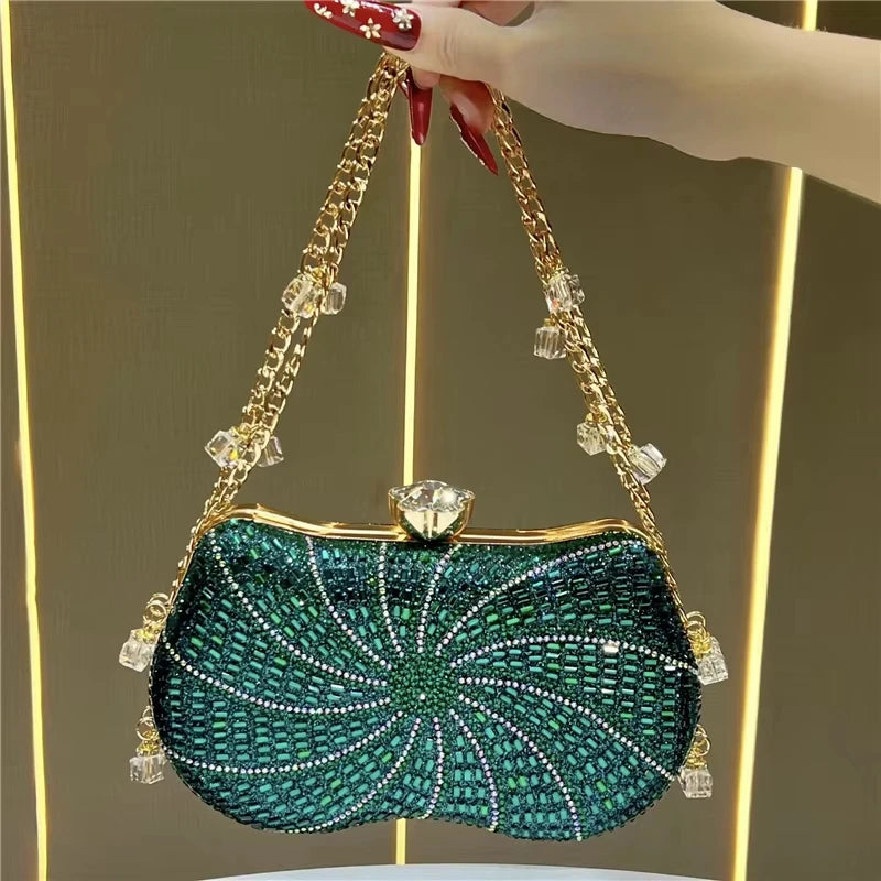 Emerald green crystal-embellished designer evening handbag with a gold chain strap, bead accents, and a crystal clasp.