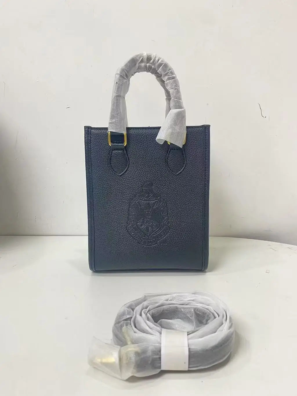 Navy blue genuine leather crossbody bag with embossed Order of the Eastern Star logo and detachable shoulder strap.