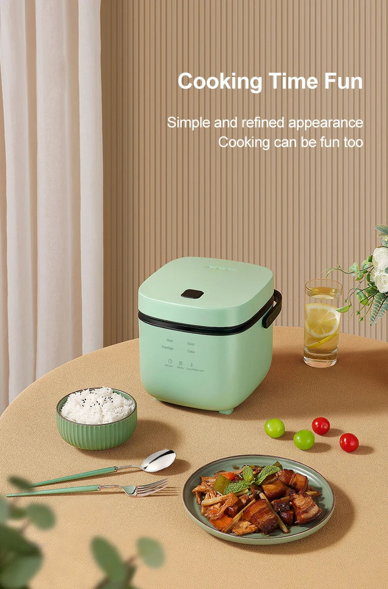 Mini electric rice cooker, mint green closed lid with side latch, meal bowl and spoon nearby