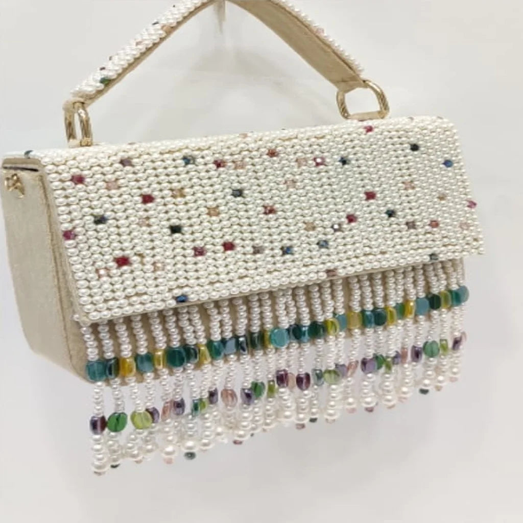Luxury ivory pearl-beaded evening handbag with colorful crystal fringe tassel, top handle, and elegant designer style.