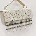 Luxury ivory pearl-beaded evening handbag with colorful crystal fringe tassel, top handle, and elegant designer style.