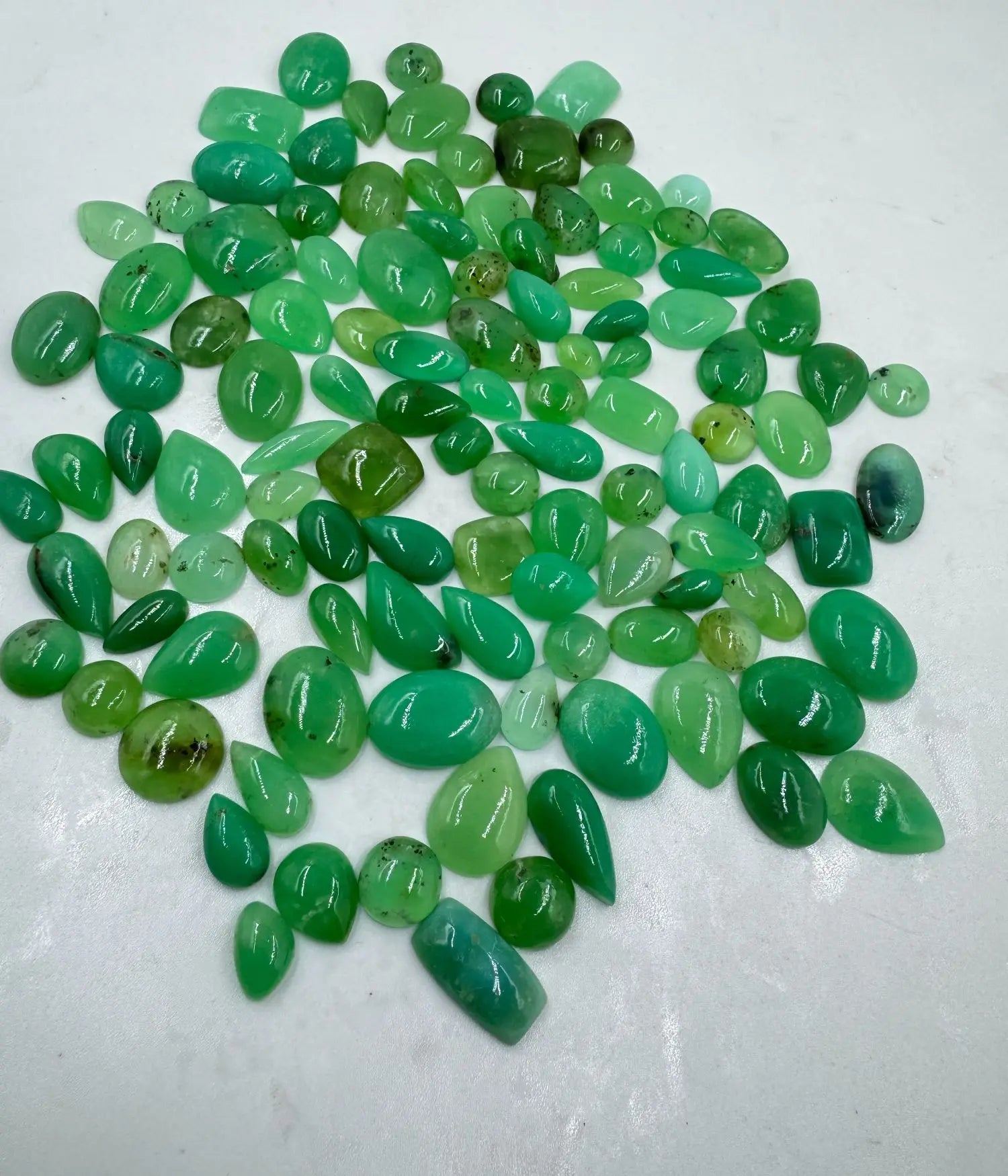 Green chrysoprase cabochons in mixed shapes, smooth oval and teardrop pieces