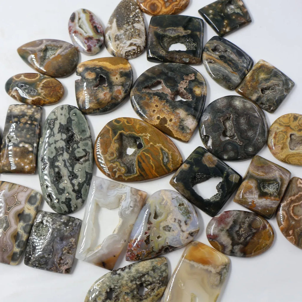 Mixed ocean jasper druzy cabochon gemstones, oval and teardrop shapes with dark and amber patterns