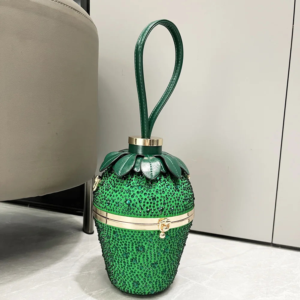 Green rhinestone strawberry evening clutch bag with gold hardware and top handle, designer bucket handbag for weddings.