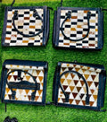 Stylish full-grain leather handbags with geometric patterns, round handles, and zip closures for daily use.