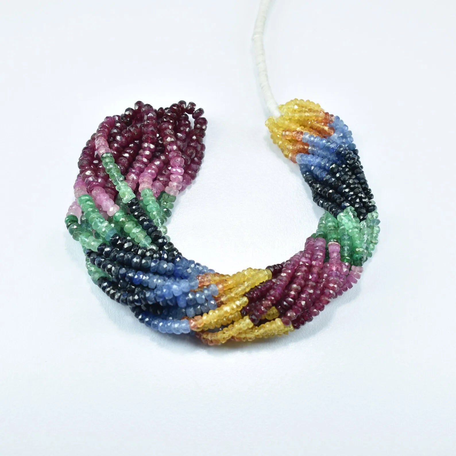 Multicolor faceted rondelle bead strand in a curled loop: maroon, green, blue, yellow