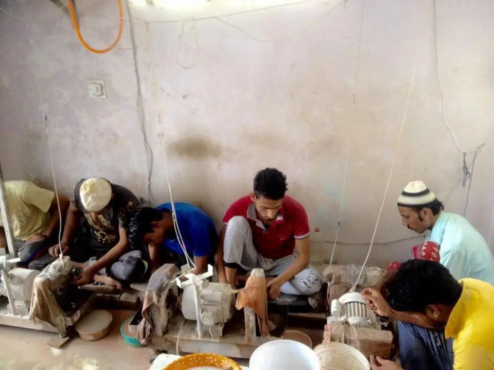 Gemstone crafting workshop scene with workers working at benches