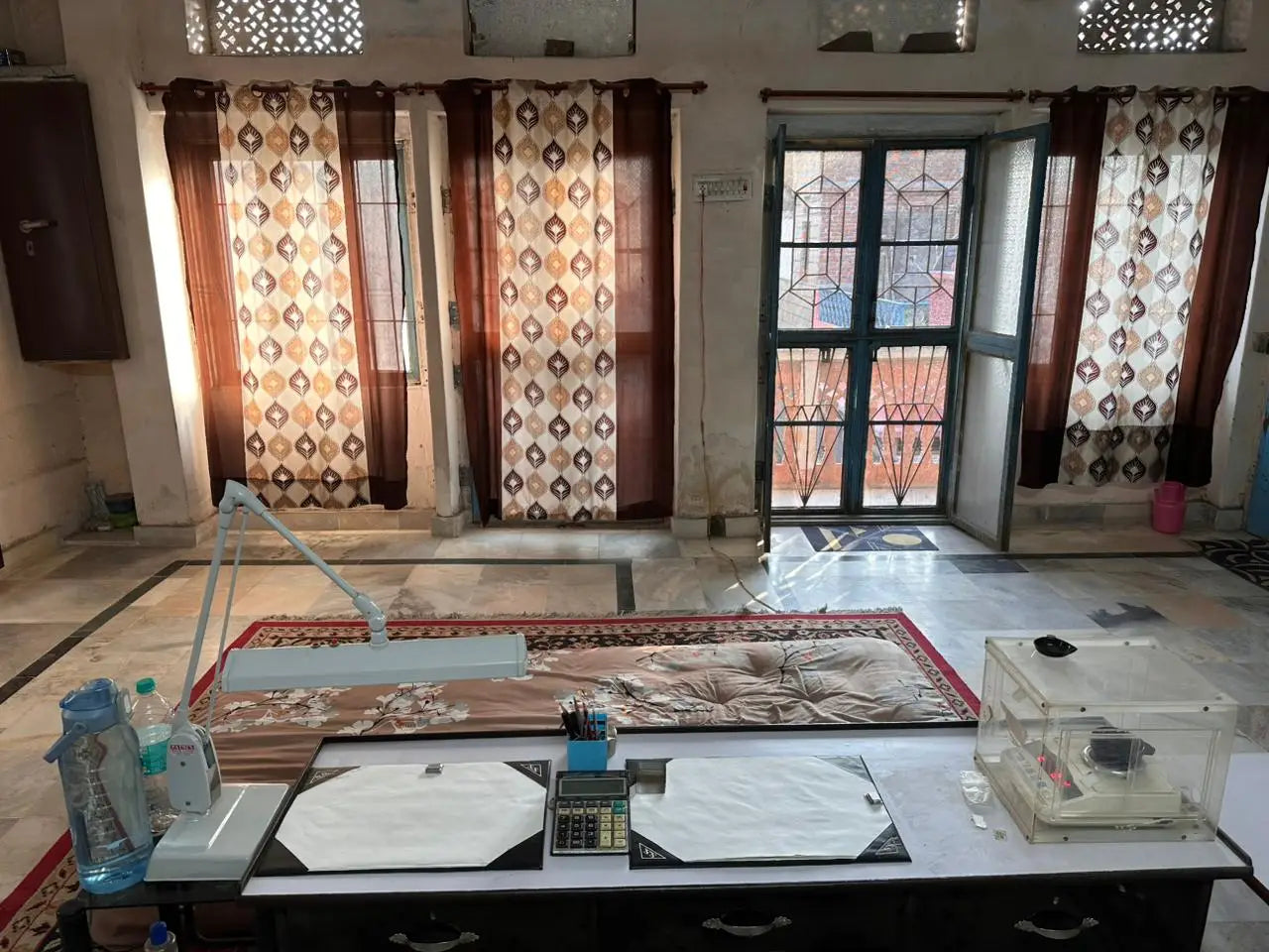 Indoor room with tables, curtains, and multiple windows