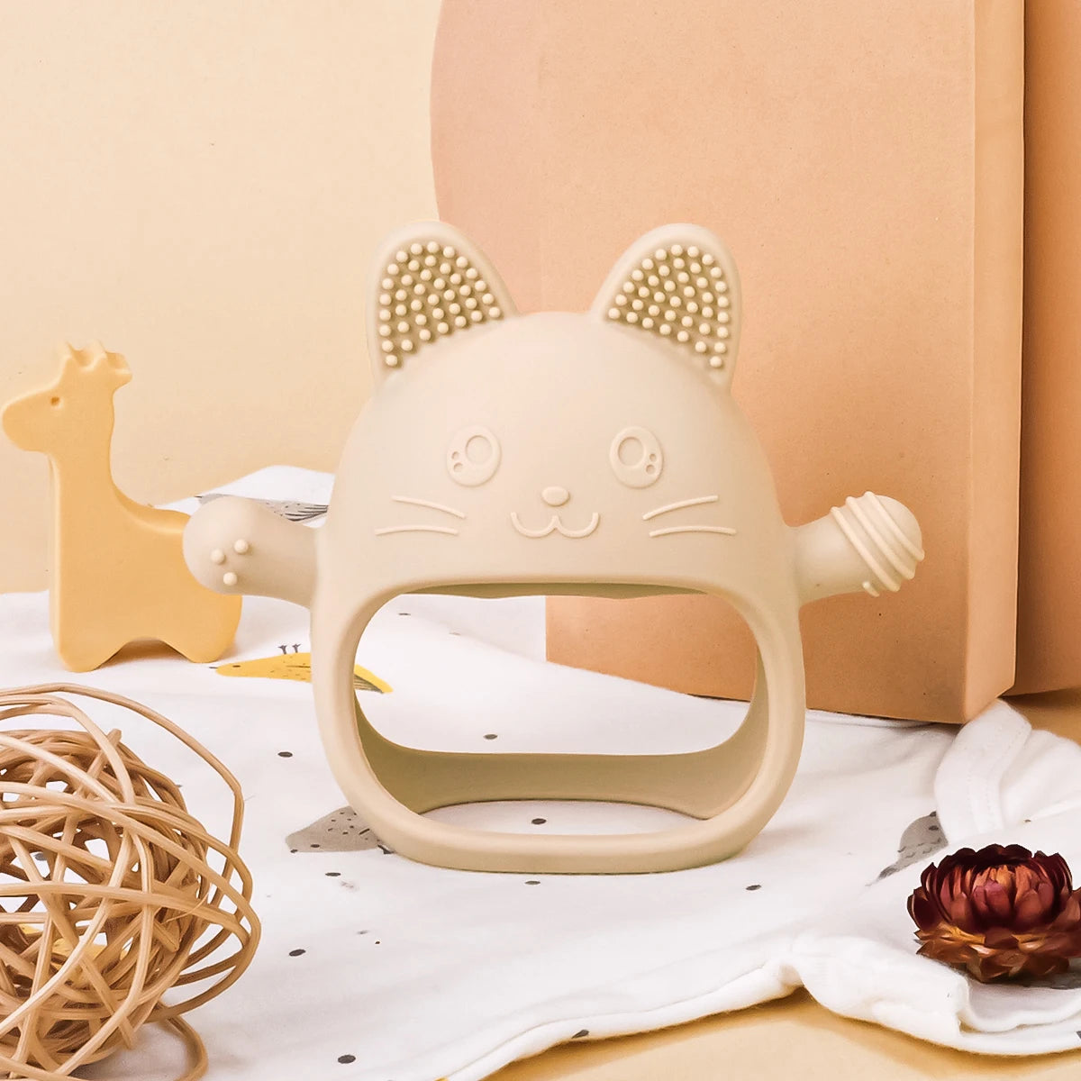 Beige cat-shaped silicone baby teething toy for soothing sore gums.