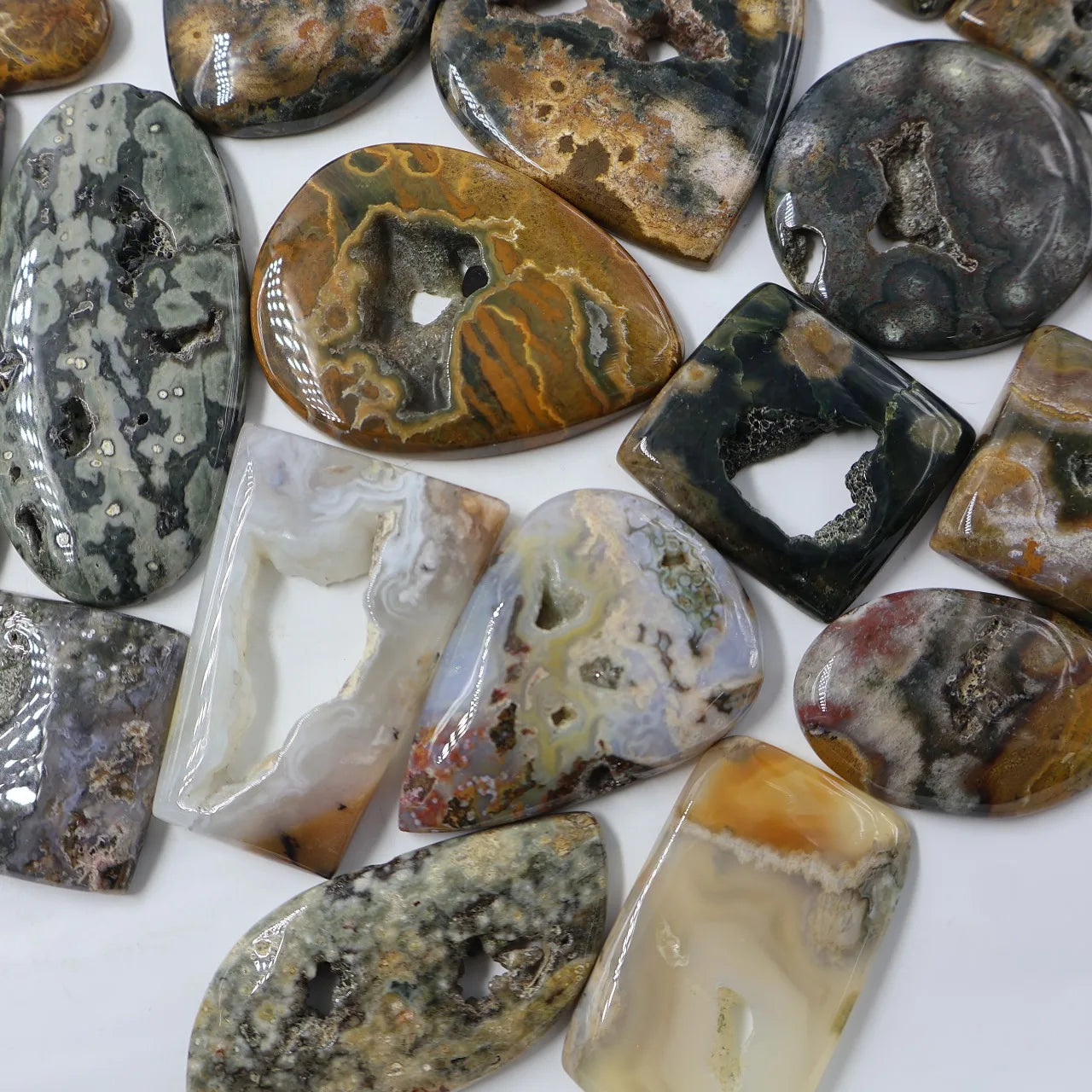 Assorted ocean jasper cabochons with druzy texture, mixed oval and rectangle settings
