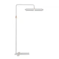 Minimalist white floor lamp with copper accents and a long, adjustable rectangular head for focused task lighting.