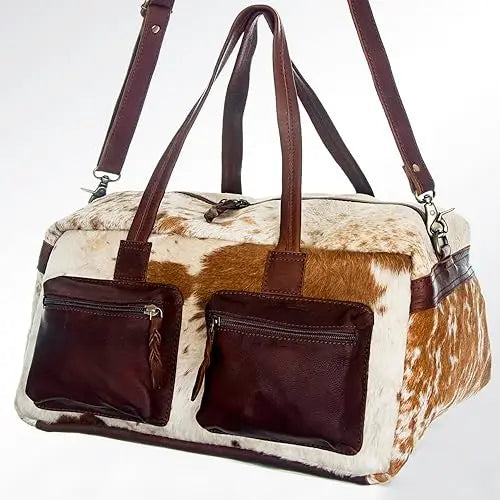 Handmade vintage cowhide leather duffel bag with brown leather front pockets, double straps, and rustic western style.