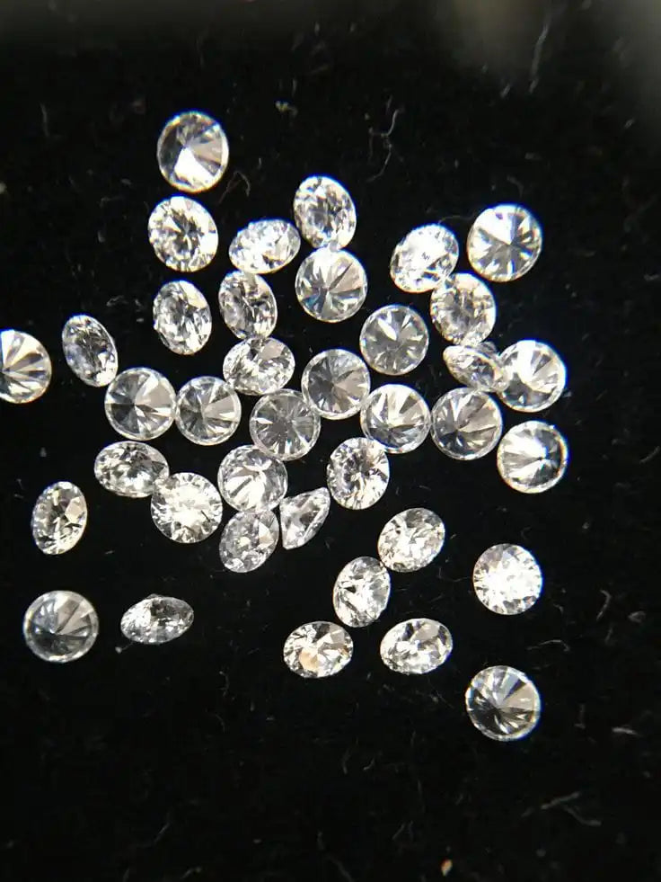 Loose round white diamonds, clustered scattered view of faceted stones