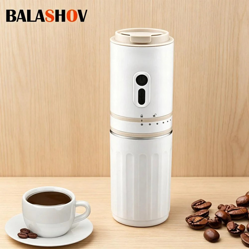 Balashov white portable electric coffee grinder and maker with cup and scattered coffee beans.