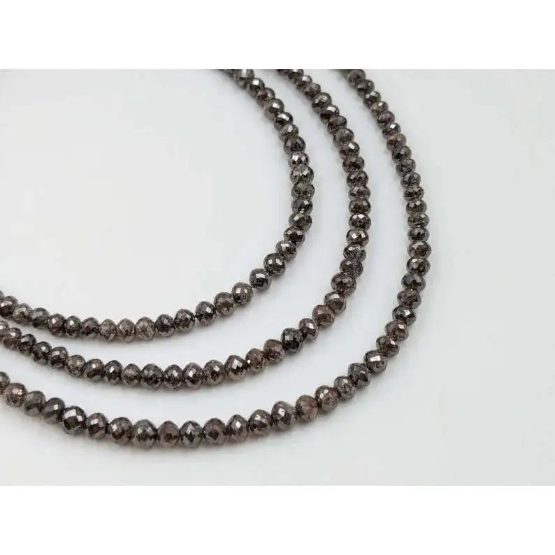 Faceted rondelle diamond bead strand with smoky dark gray sparkle on wire