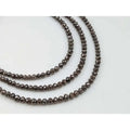 Faceted rondelle diamond bead strand with smoky dark gray sparkle on wire