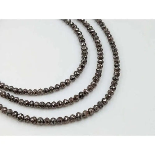 Faceted rondelle diamond bead strand with smoky dark gray sparkle on wire