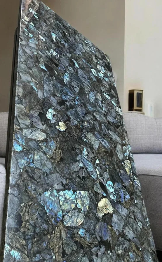 Labradorite gemstone slab end panel with blue highlights and gold-toned stone pieces