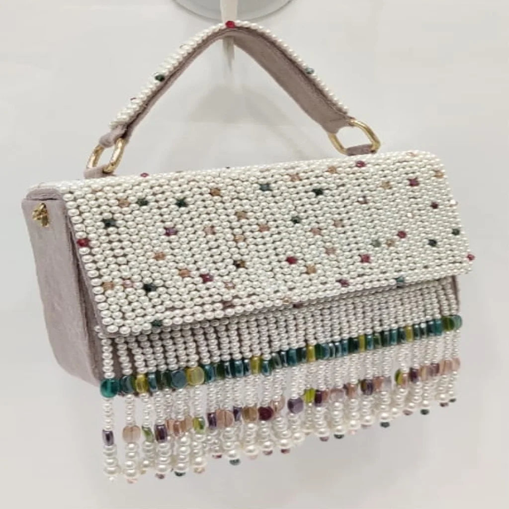 Handmade ivory pearl beaded evening clutch with colorful crystal fringe and top handle, perfect for elegant weddings.