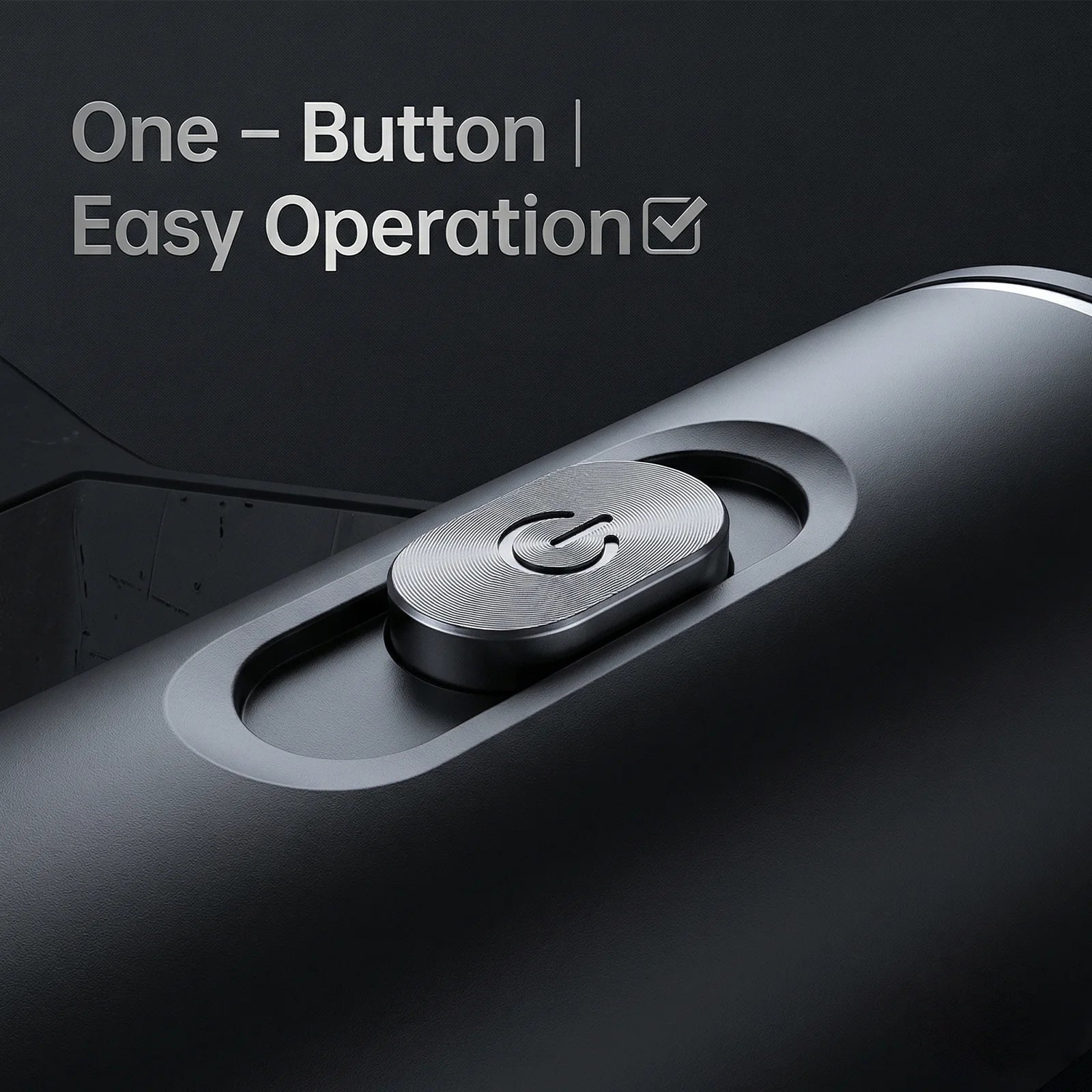 Close-up of a sleek matte black coffee maker featuring a circular metallic power button for easy one-button operation.