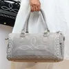 Grey handmade leather duffel trunk with elegant boot stitch design for stylish weekend travel.