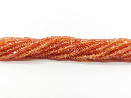 Orange faceted rondelle bead strand, close-up view of layered rows on white.