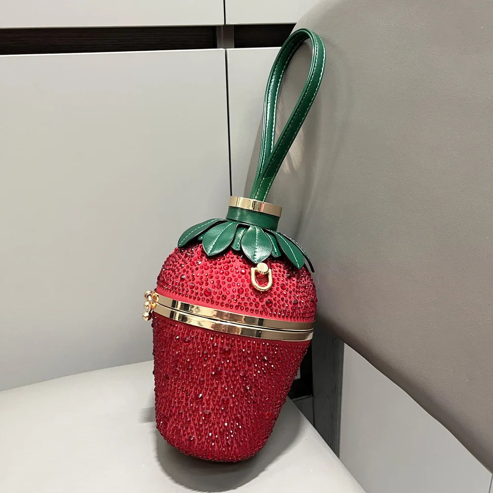 Crystal rhinestone strawberry evening clutch handbag with green leather handle, luxury designer bucket bag for weddings.