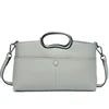 Grey PU leather designer handbag with circular top handles and detachable crossbody strap.