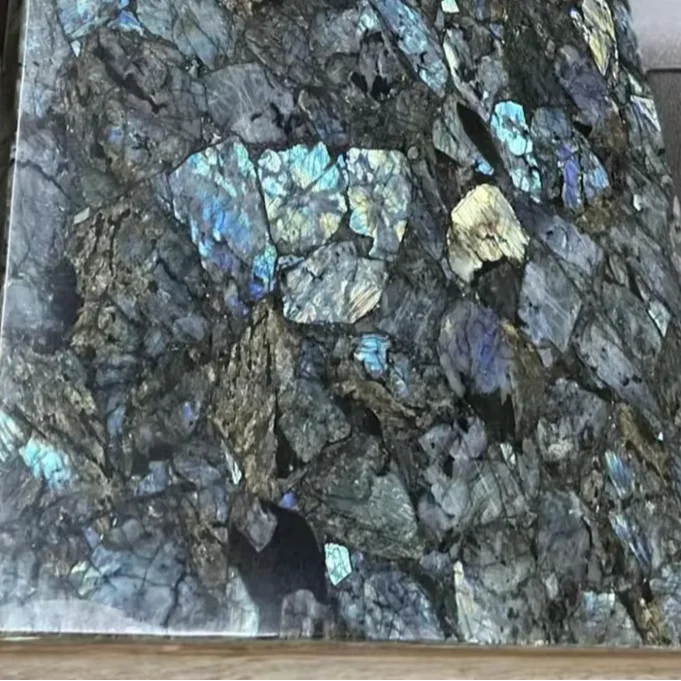 Labradorite gemstone tabletop with dark gray surface and blue iridescent flecks