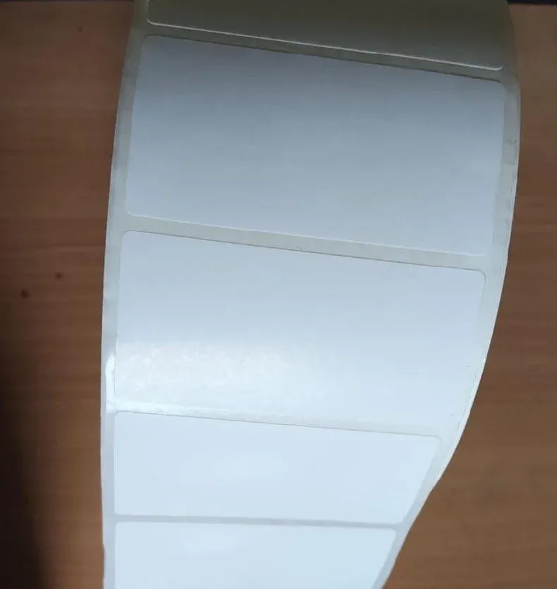 Blank white adhesive label sheet on backing with three rectangular label sections