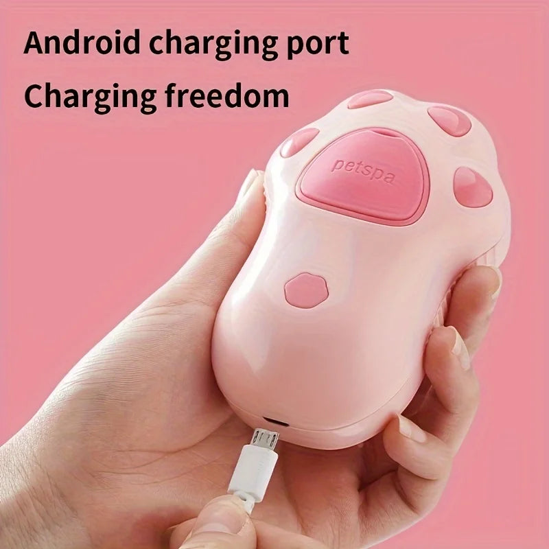 Pink paw-shaped electric steam pet grooming brush being charged, perfect for hair removal and massage for cats and dogs.