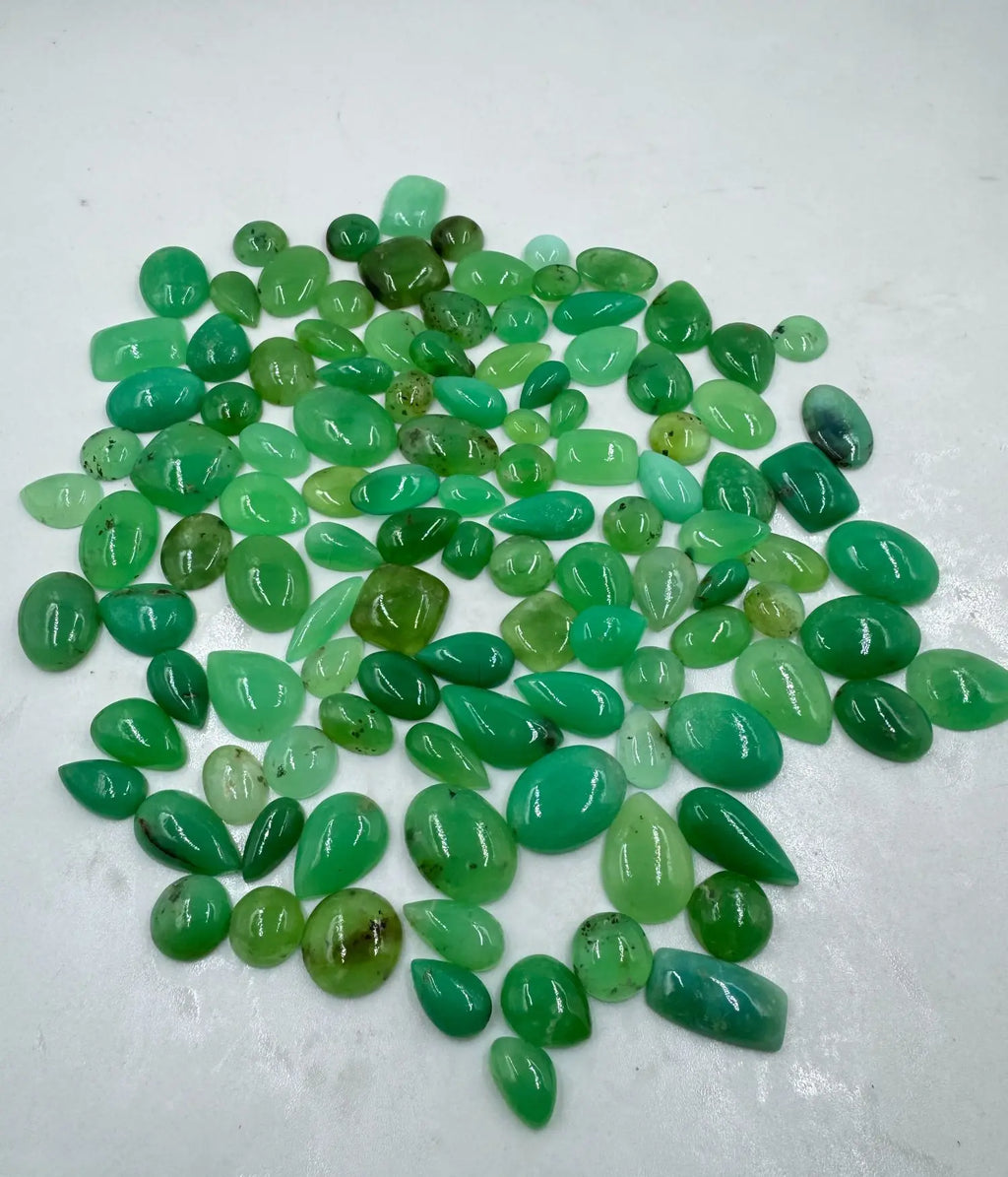 Assorted green gemstone cabochon mix with smooth oval and teardrop pieces