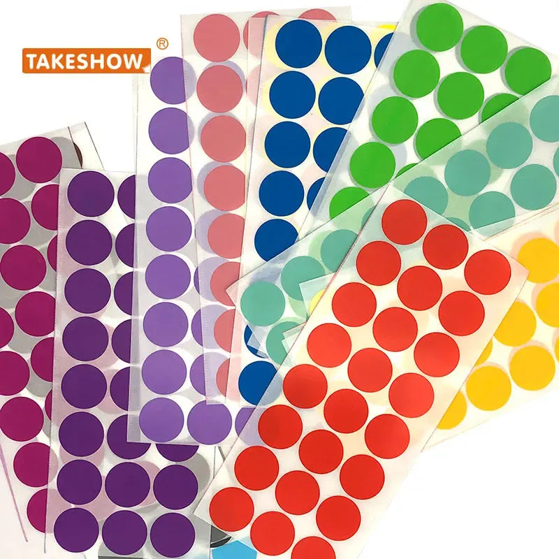 Multiple round dot sticker sheets in purple, blue, green, and coral